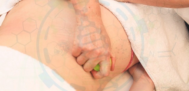Close-up of a practitioner applying instrument-assisted soft tissue mobilization to a patient's back, overlaid with a technical digital tracking grid to represent the science behind Gua Sha therapy