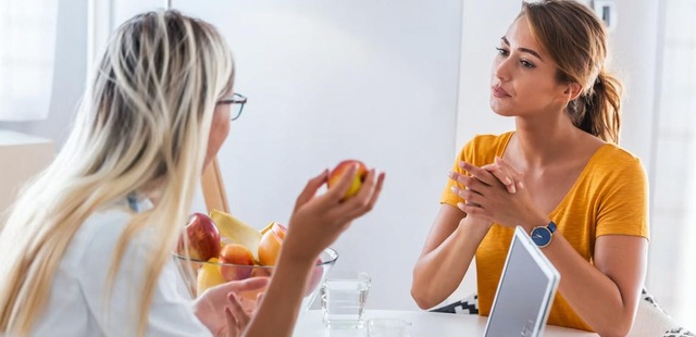 A patient discussing chronic symptoms with a practitioner during a naturopathic nutrition essex intake consultation