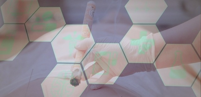 Clinical moxibustion therapy session at Acufy Clinic in Essex, showing a practitioner utilizing an indirect burning moxa roll to demonstrate the thermal microvascular physiology and peer-reviewed science behind our care in Maldon.