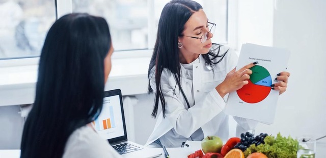 Practitioner explaining a metabolic breakdown chart during a naturopathic nutrition essex clinical consultation with a patient